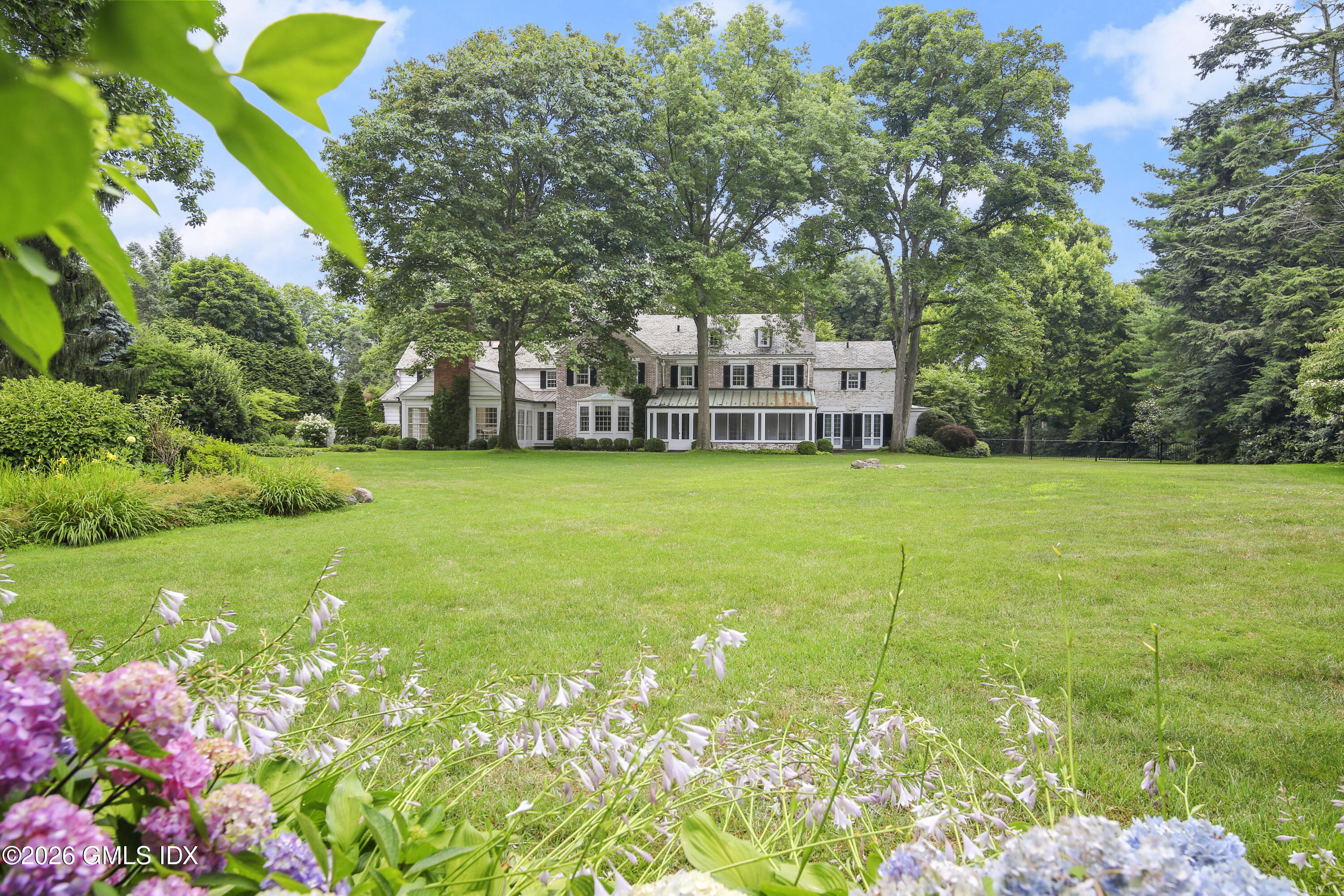 12 Woodside Road Greenwich, CT 06830 - Photo 6 of 7 a view of a house with a garden