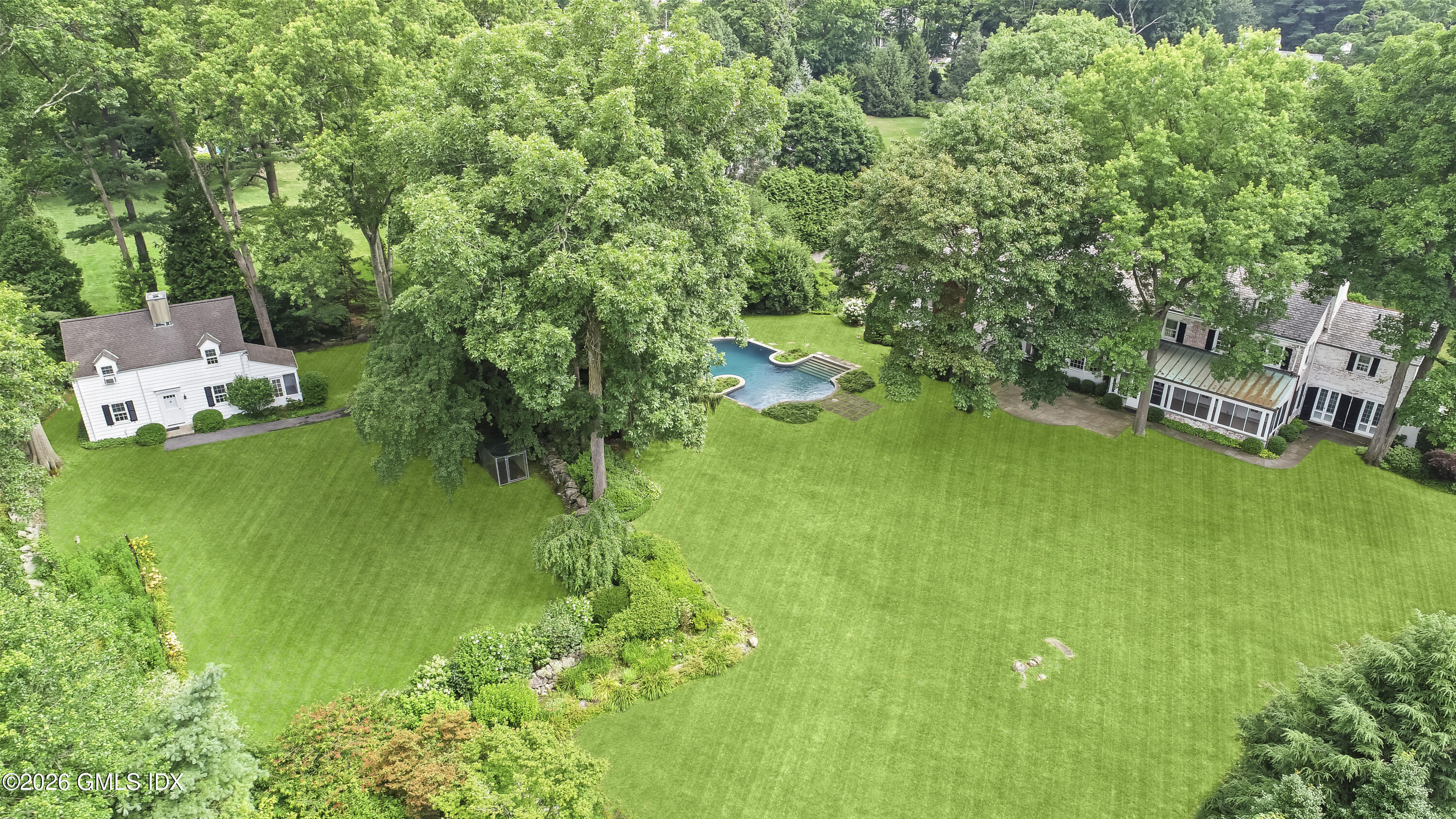 12 Woodside Road Greenwich, CT 06830 - Photo 10 of 11 a view of a house with a yard