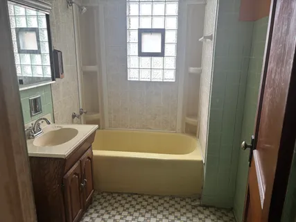 a bathroom with a sink a bathtub and a shower