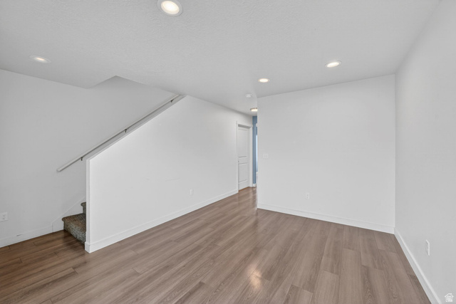 295 Spruce Way Santaquin, UT 84655 - Photo 5 of 32 Open-concept area featuring wood-finish flooring, recessed lighting, and white walls
