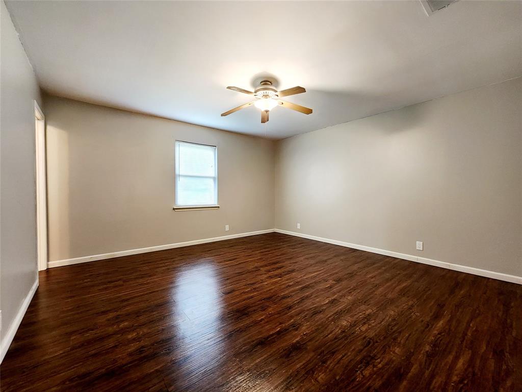 3514 Buchanan Loop Road Texarkana, TX 75501 - Photo 16 of 40 a view of a room with wooden floor and a ceiling fan