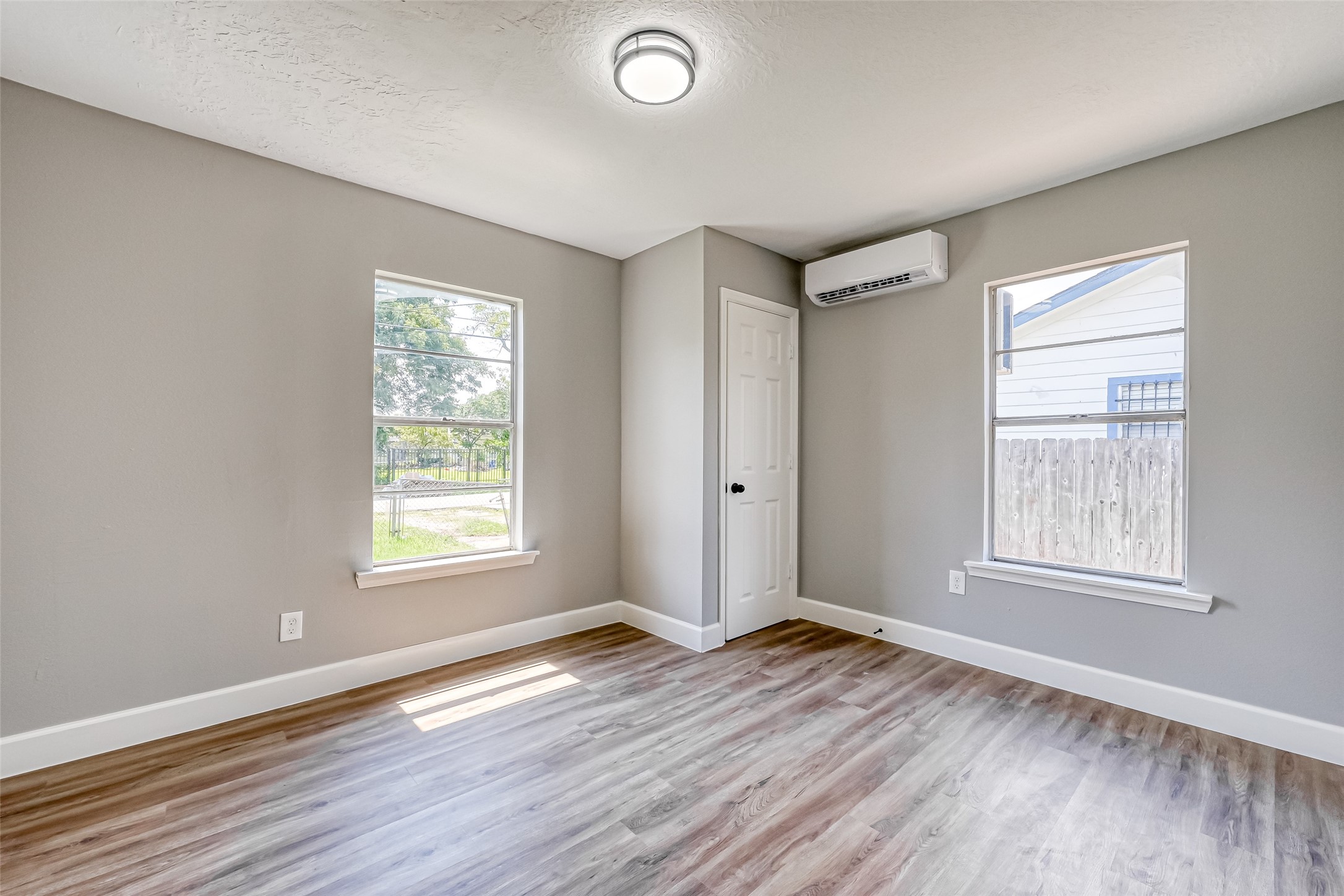 6715 Victoria Street Houston, TX 77020 - Photo 10 of 46 a view of an empty room with wooden floor and a window