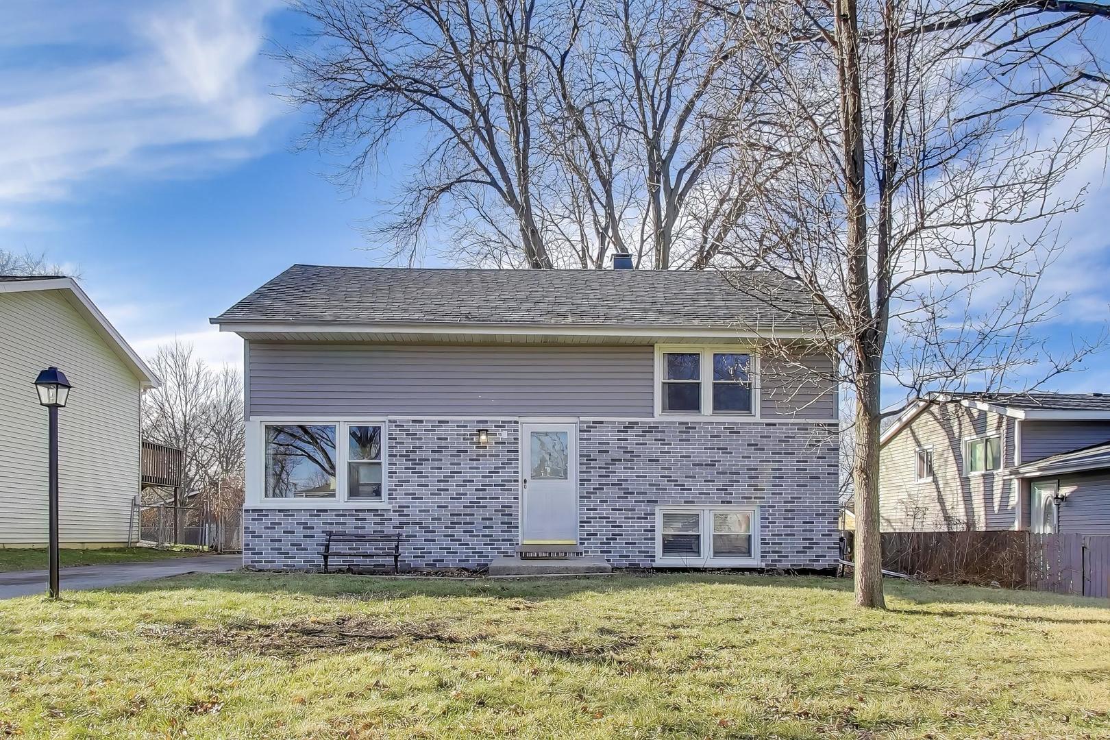 046 North Page Street Winfield, IL 60190 - Photo 1 of 32 a front view of a house with a garden