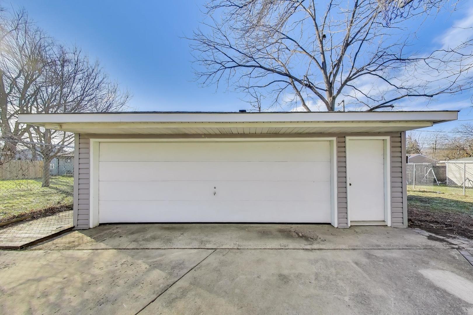 046 North Page Street Winfield, IL 60190 - Photo 28 of 32 a front view of a house with garden