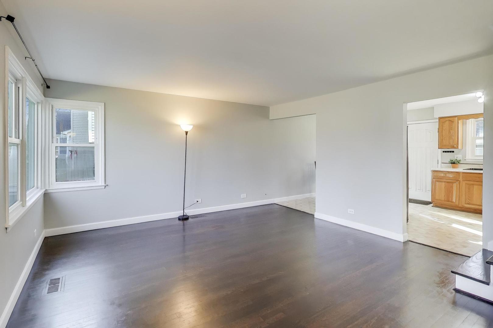 046 North Page Street Winfield, IL 60190 - Photo 4 of 32 an empty room with wooden floor and windows