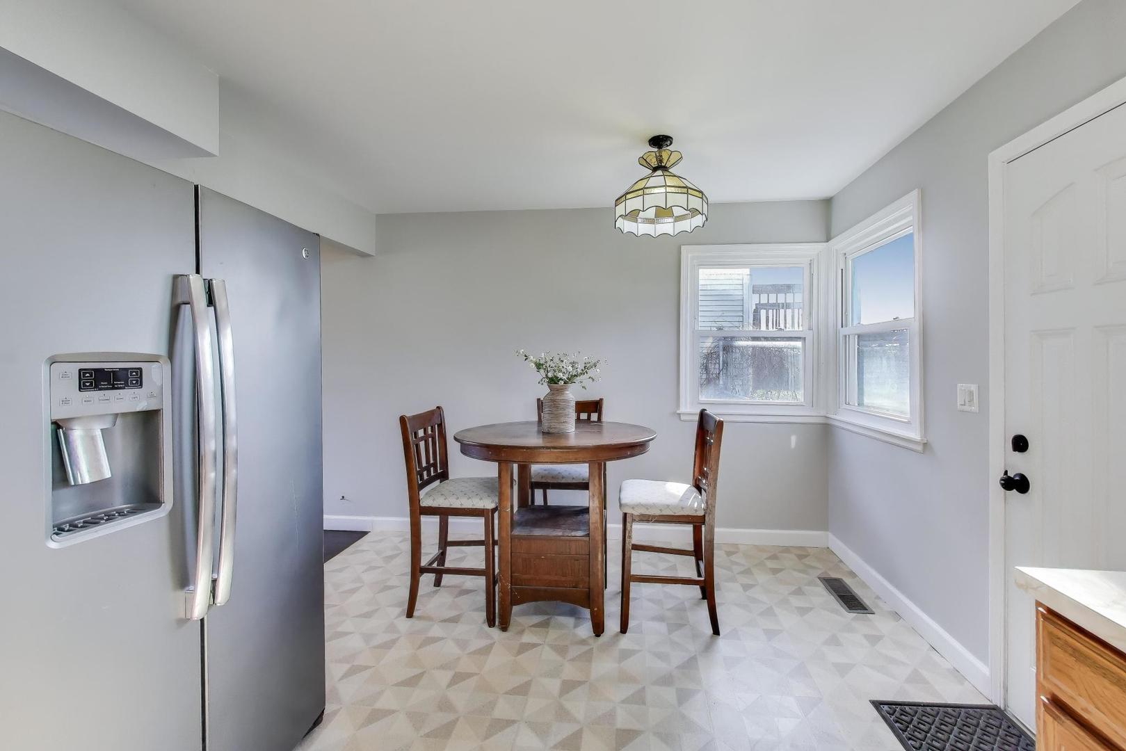046 North Page Street Winfield, IL 60190 - Photo 9 of 32 a view of a dining room with furniture window and wooden floor