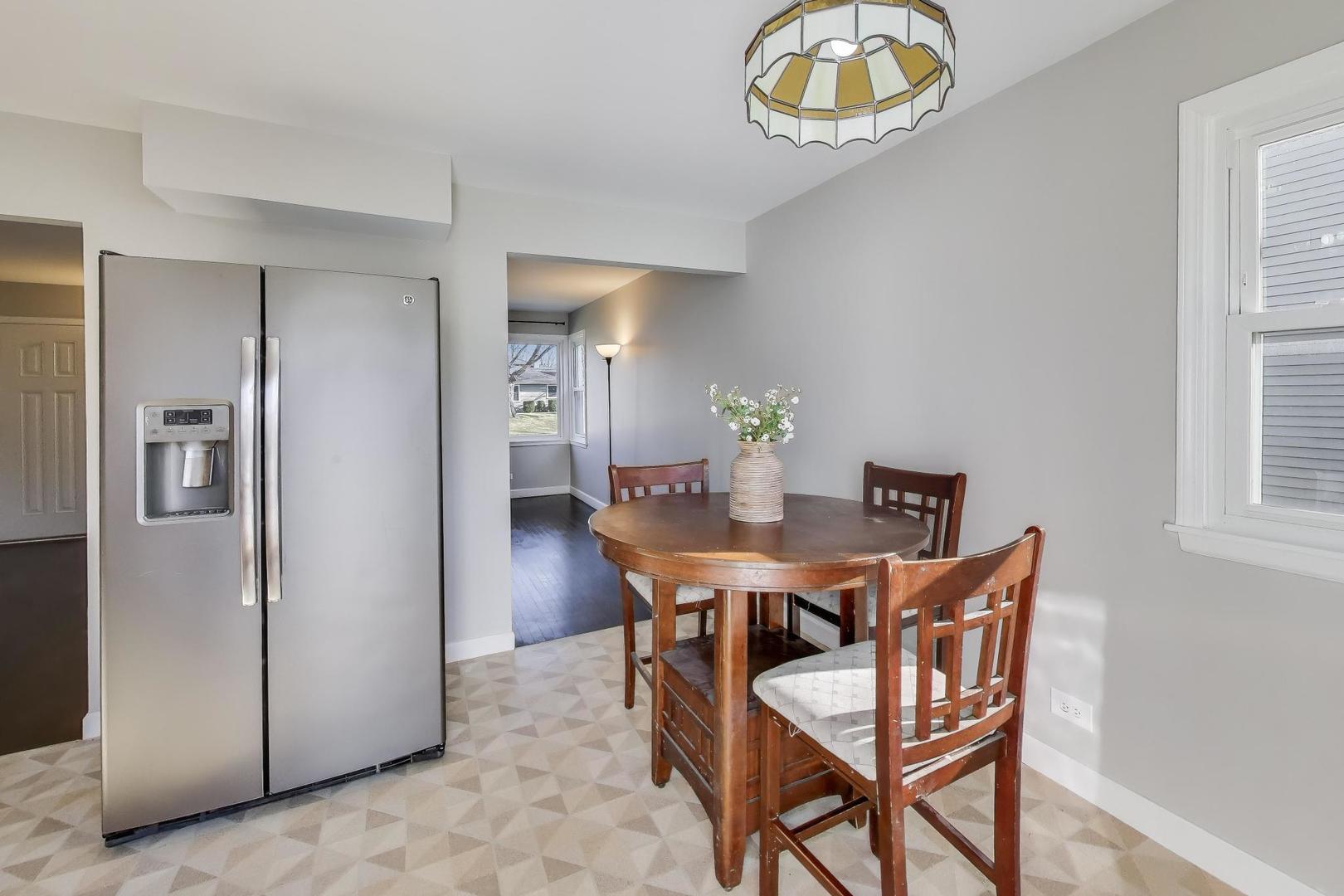 046 North Page Street Winfield, IL 60190 - Photo 10 of 32 a view of a dining room with furniture and a chandelier