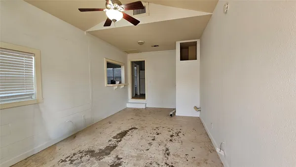 a view of a hallway with a chandelier fan