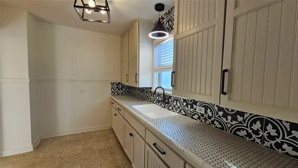 a bathroom with a double vanity sink and a mirror