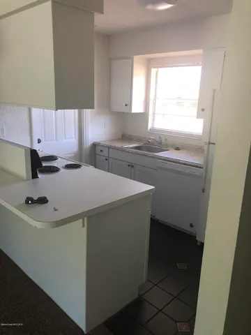 a kitchen with a sink cabinets and window