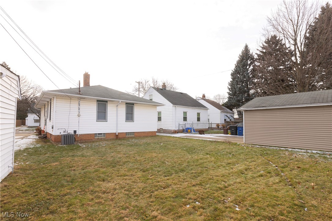 4354 Redding Road Cleveland, OH 44109 - Photo 23 of 23 Back of house with central AC unit and a lawn