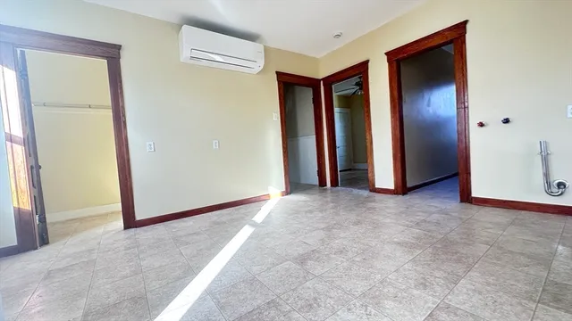 an empty room with closet and a bathroom