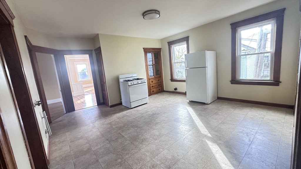 3 Bowker Street Worcester, MA 01604 - Photo 16 of 42 a view of an empty room with a fireplace and a window