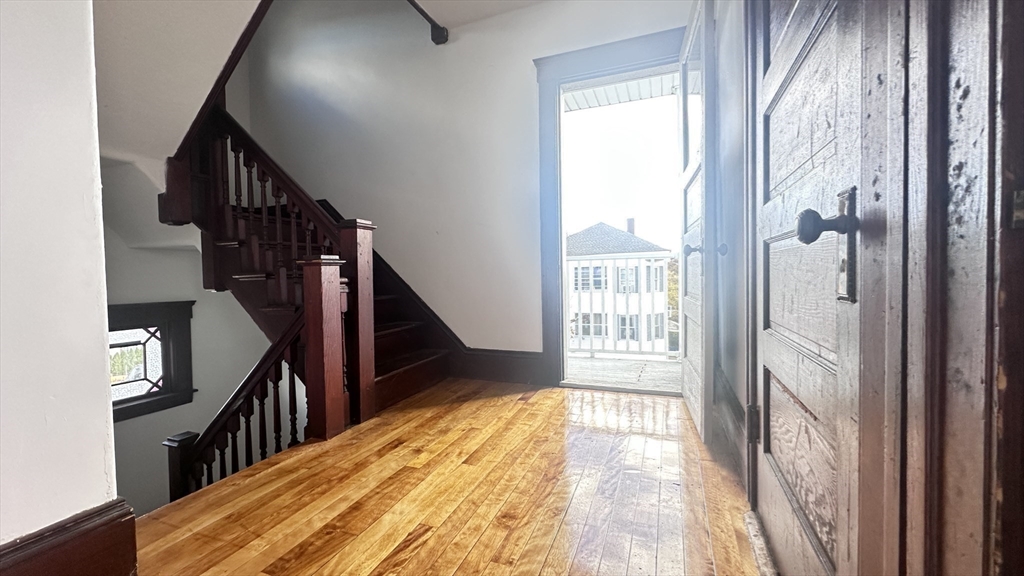 3 Bowker Street Worcester, MA 01604 - Photo 25 of 42 a view of a hallway with wooden floor and windows