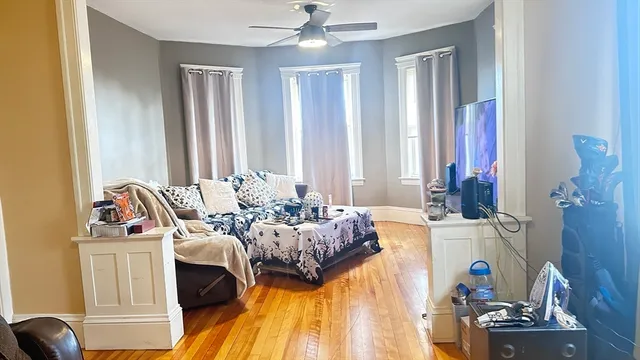 a living room with furniture and wooden floor