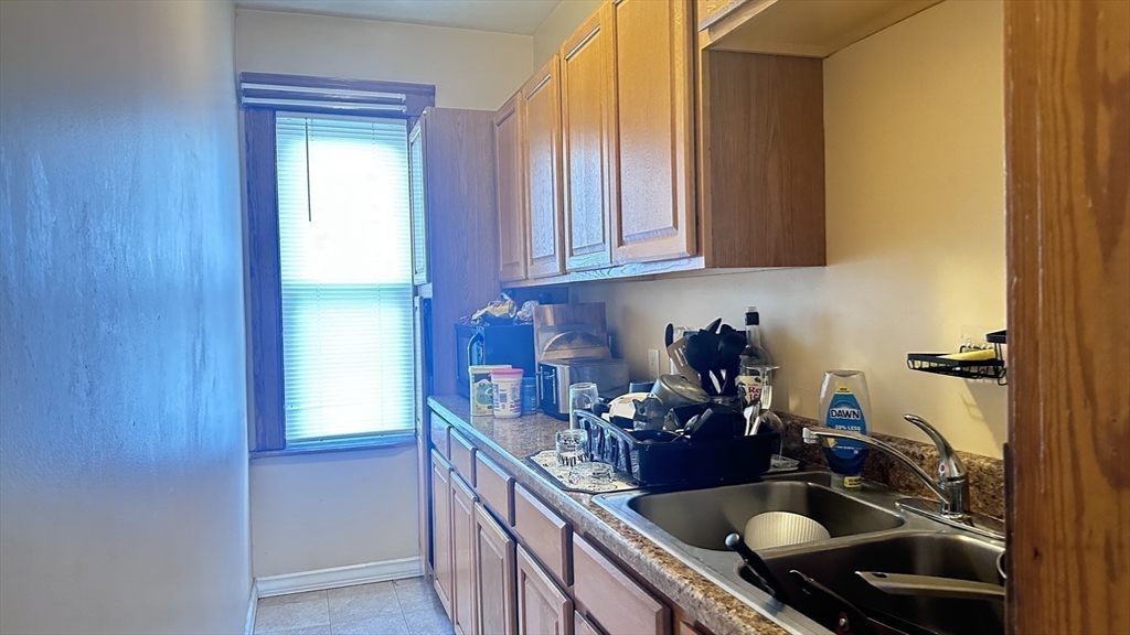 3 Bowker Street Worcester, MA 01604 - Photo 32 of 42 a kitchen with a sink and cabinets