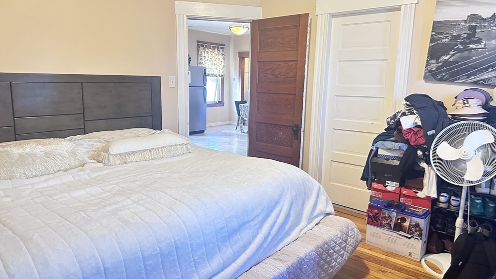 3 Bowker Street Worcester, MA 01604 - Photo 34 of 42 a bedroom with a bed and wooden floor