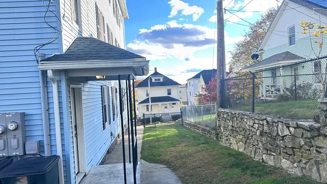 a view of a house with backyard and sitting area
