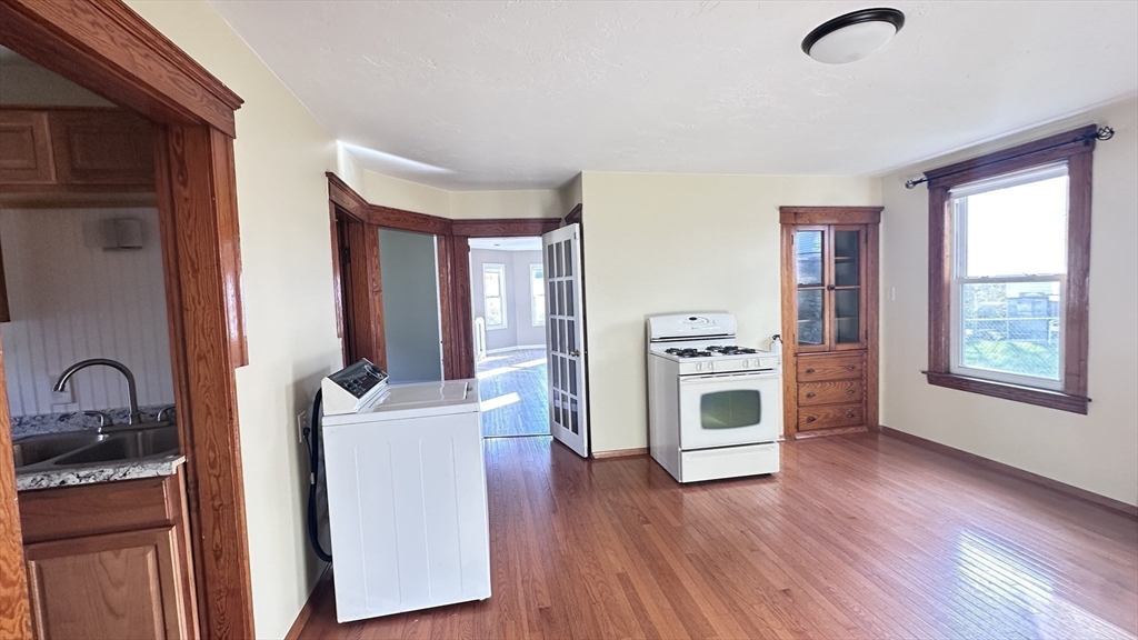 3 Bowker Street Worcester, MA 01604 - Photo 4 of 42 a kitchen with stainless steel appliances granite countertop a stove a sink dishwasher and a refrigerator with wooden floor