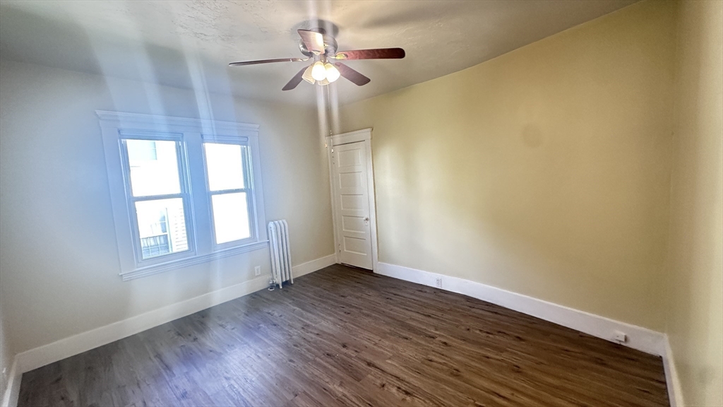 3 Bowker Street Worcester, MA 01604 - Photo 9 of 42 an empty room with wooden floor chandelier fan and windows
