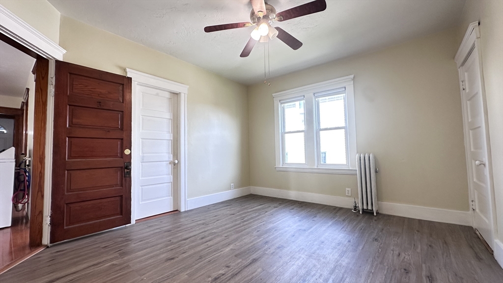 3 Bowker Street Worcester, MA 01604 - Photo 10 of 42 an empty room with wooden floor closet and windows