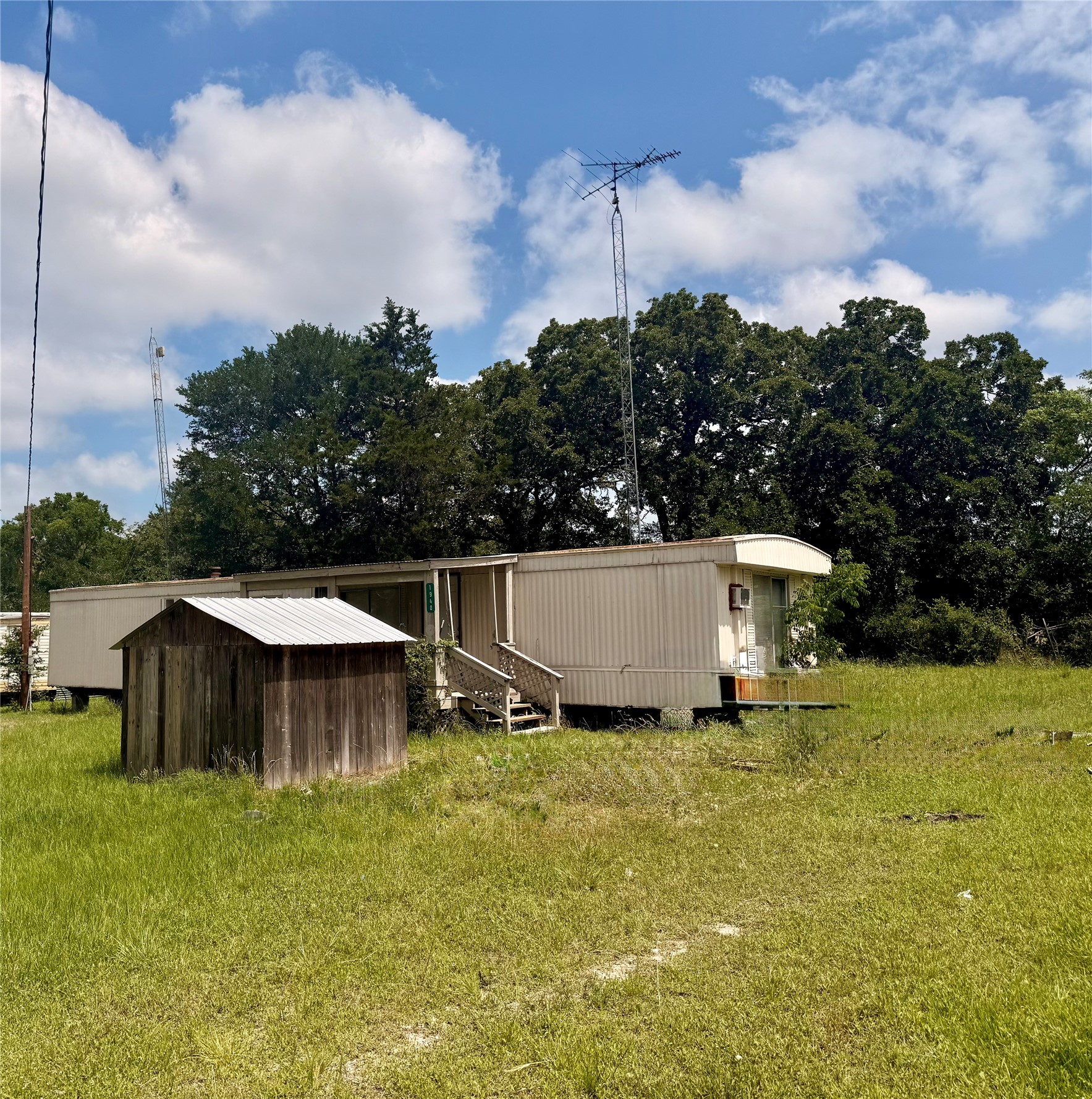 1940 Smoky Road Brenham, TX 77833 - Photo 4 of 14 a backyard of a house with table and chairs plants and barbeque oven