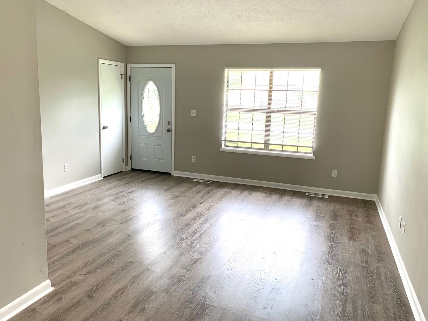 208 State Line Road Clarksville, TN 37042 - Photo 2 of 23 an empty room with wooden floor and windows