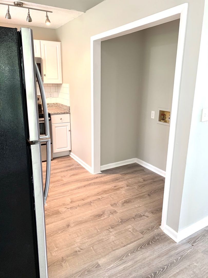 208 State Line Road Clarksville, TN 37042 - Photo 7 of 23 a view of an empty room with wooden floor and a window