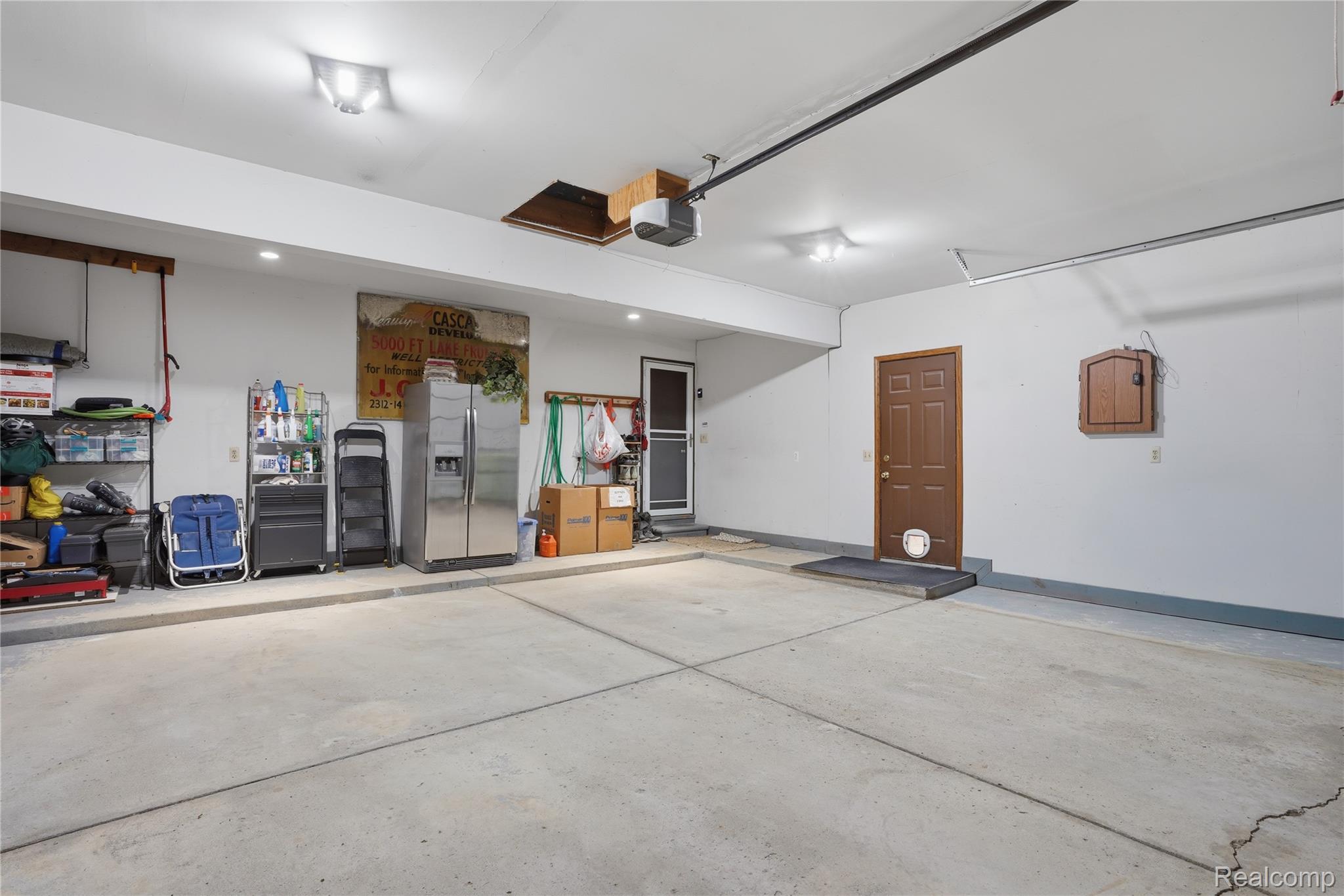 68345 Romeo Plank Road Ray, MI 48096 - Photo 42 of 52 Spacious garage featuring a concrete floor, bright overhead lighting, and an interior access door