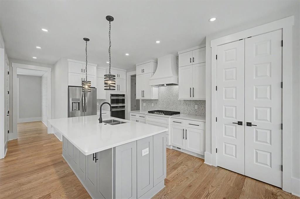 217 Laura Lake Road Marietta, GA 30066 - Photo 20 of 54 a large kitchen with stainless steel appliances kitchen island a large counter top and stove