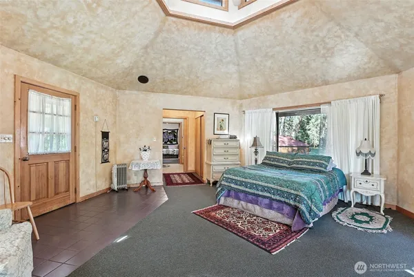 a bedroom with a bed and window