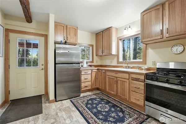 a kitchen with a refrigerator stove and sink