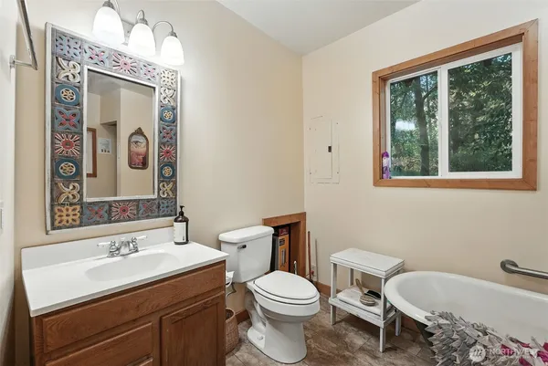 a bathroom with a toilet sink and mirror