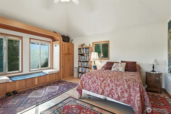 a bedroom with a large bed and a window