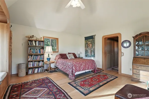 a bedroom with bed and a bookshelf