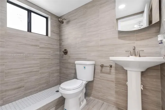 a bathroom with a sink toilet and mirror