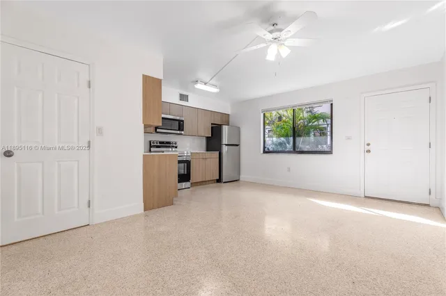 a view of a kitchen with furniture and a ceiling fan