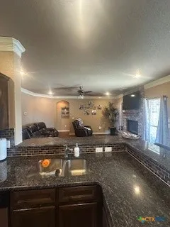 a kitchen with a sink a stove a refrigerator and chairs