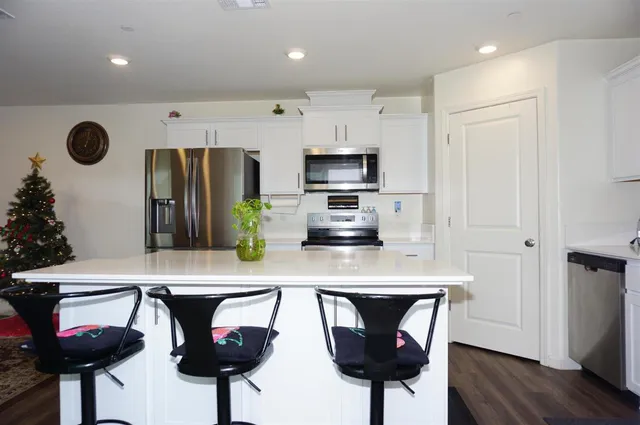 a kitchen with a stove a sink and a refrigerator