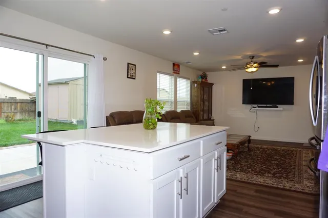 a kitchen with a table chairs refrigerator and microwave