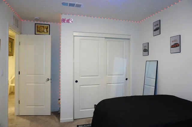 a living room with lots of furniture and baby crib