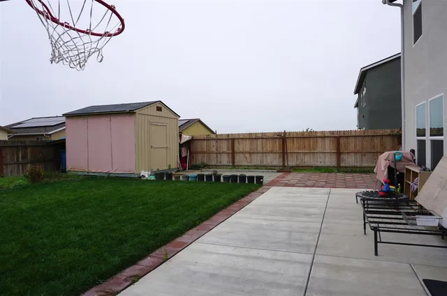 a view of a house with a yard and pathway