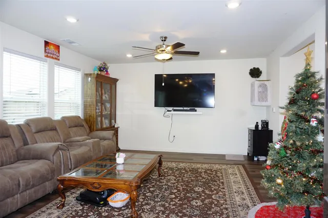 a living room with furniture gym equipment and a chandelier