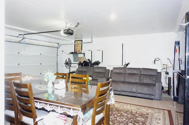 a living room with furniture a flat screen tv and a window