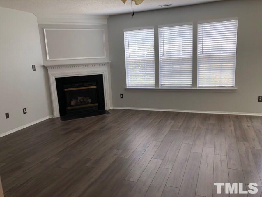 6120 Saybrooke Drive Raleigh, NC 27604 - Photo 2 of 7 a view of a livingroom with a fireplace and window