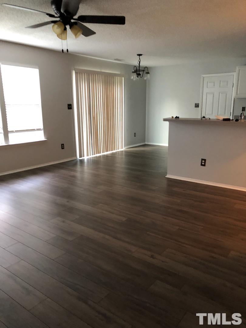 6120 Saybrooke Drive Raleigh, NC 27604 - Photo 3 of 7 an empty room with wooden floor and windows