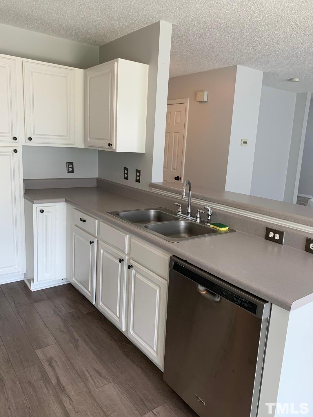 6120 Saybrooke Drive Raleigh, NC 27604 - Photo 5 of 7 a kitchen with a sink cabinets and wooden floor