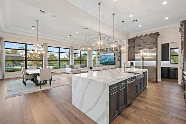 a kitchen with stainless steel appliances granite countertop a sink and refrigerator