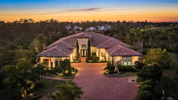 a front view of house with yard and green space