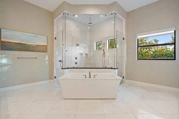 a bathroom with a toilet a sink a mirror a shower and vanity